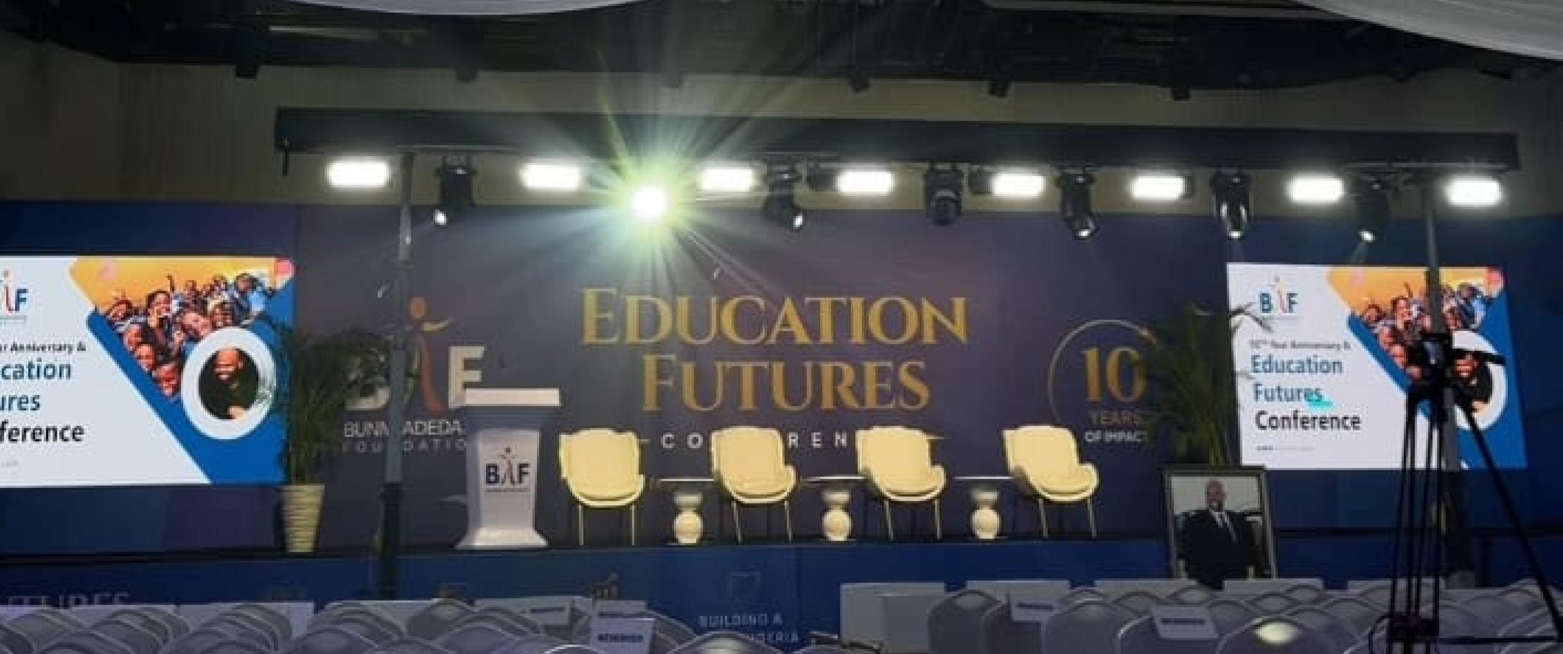 Wide view of the lit Education Futures Conference stage