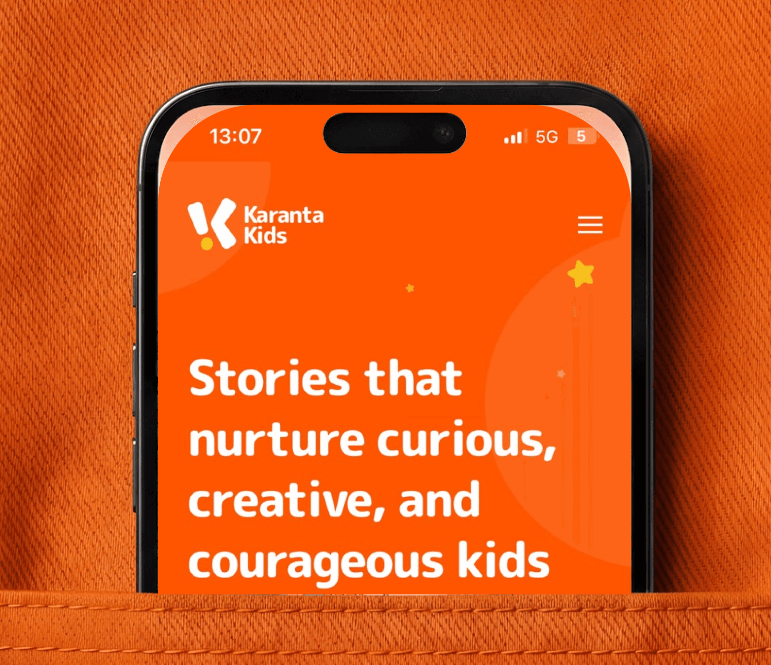 Karanta Kids website on a phone in an orange pocket